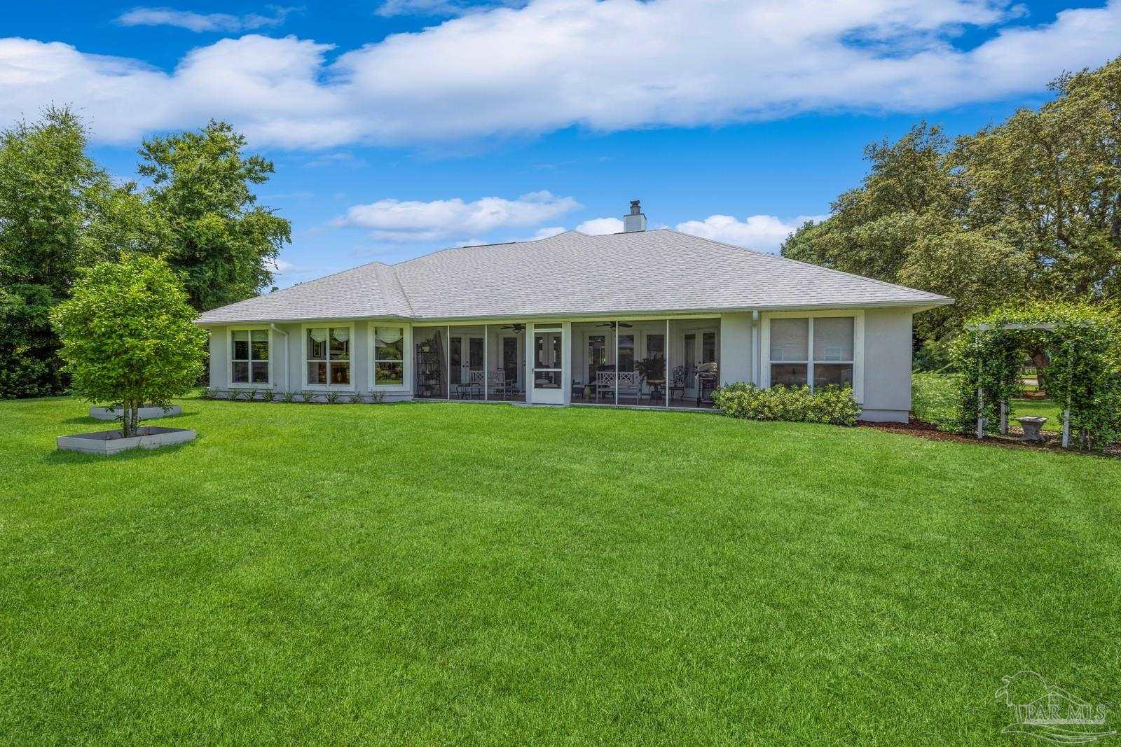 2808 P.G.A Boulevard Navarre, FL 32566 - Photo 40 of 54 a front view of a house with a garden