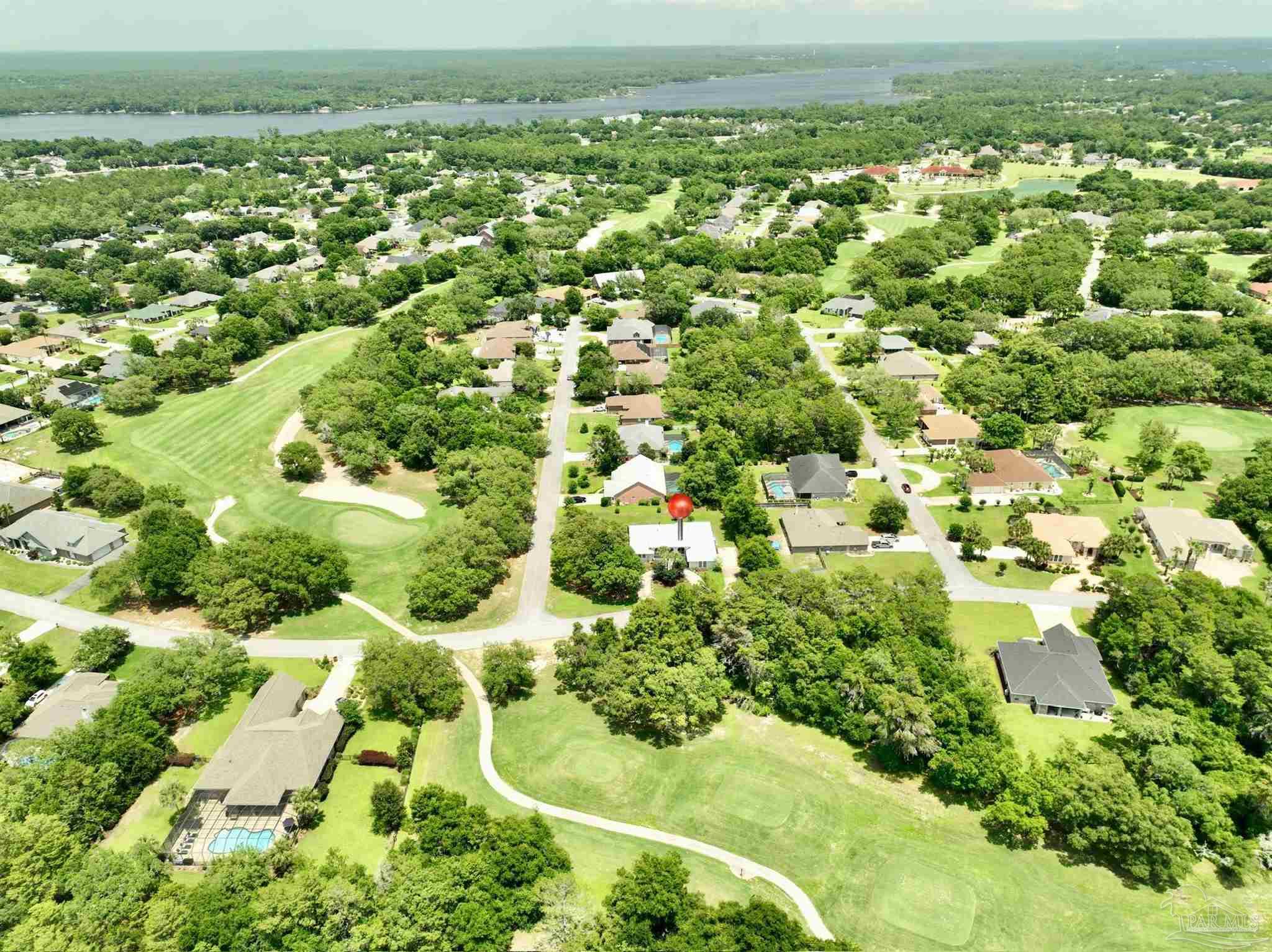 2808 P.G.A Boulevard Navarre, FL 32566 - Photo 45 of 54 an aerial view of residential houses with outdoor space and trees