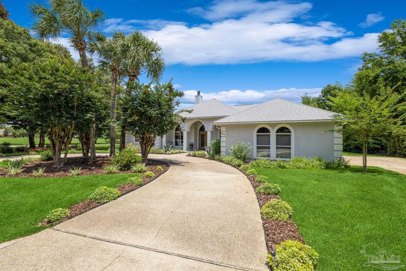 2808 P.G.A Boulevard Navarre, FL 32566 - Photo 46 of 54 a front view of a house with a garden