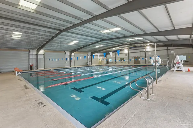 an aerial view of residential houses with outdoor space and river