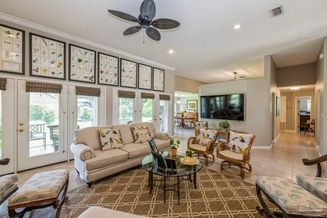 a living room with furniture a flat screen tv and a large window