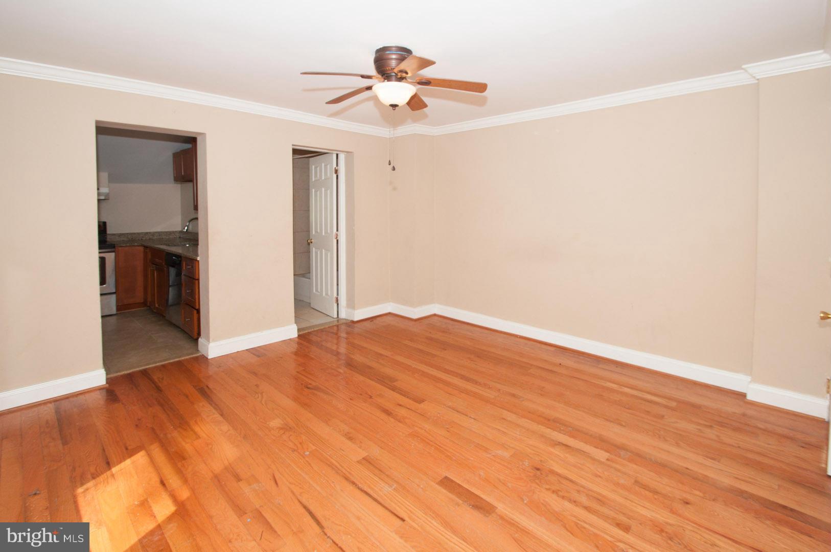 6216 Falls Road Baltimore, MD 21209 - Photo 3 of 8 a view of empty room with wooden floor