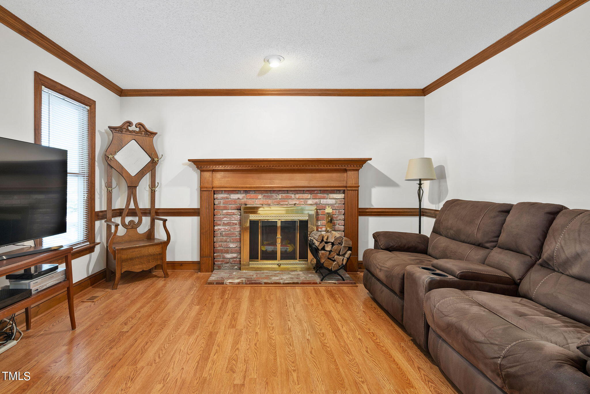 3205 Flintshire Road Raleigh, NC 27604 - Photo 5 of 31 a living room with furniture and a fireplace