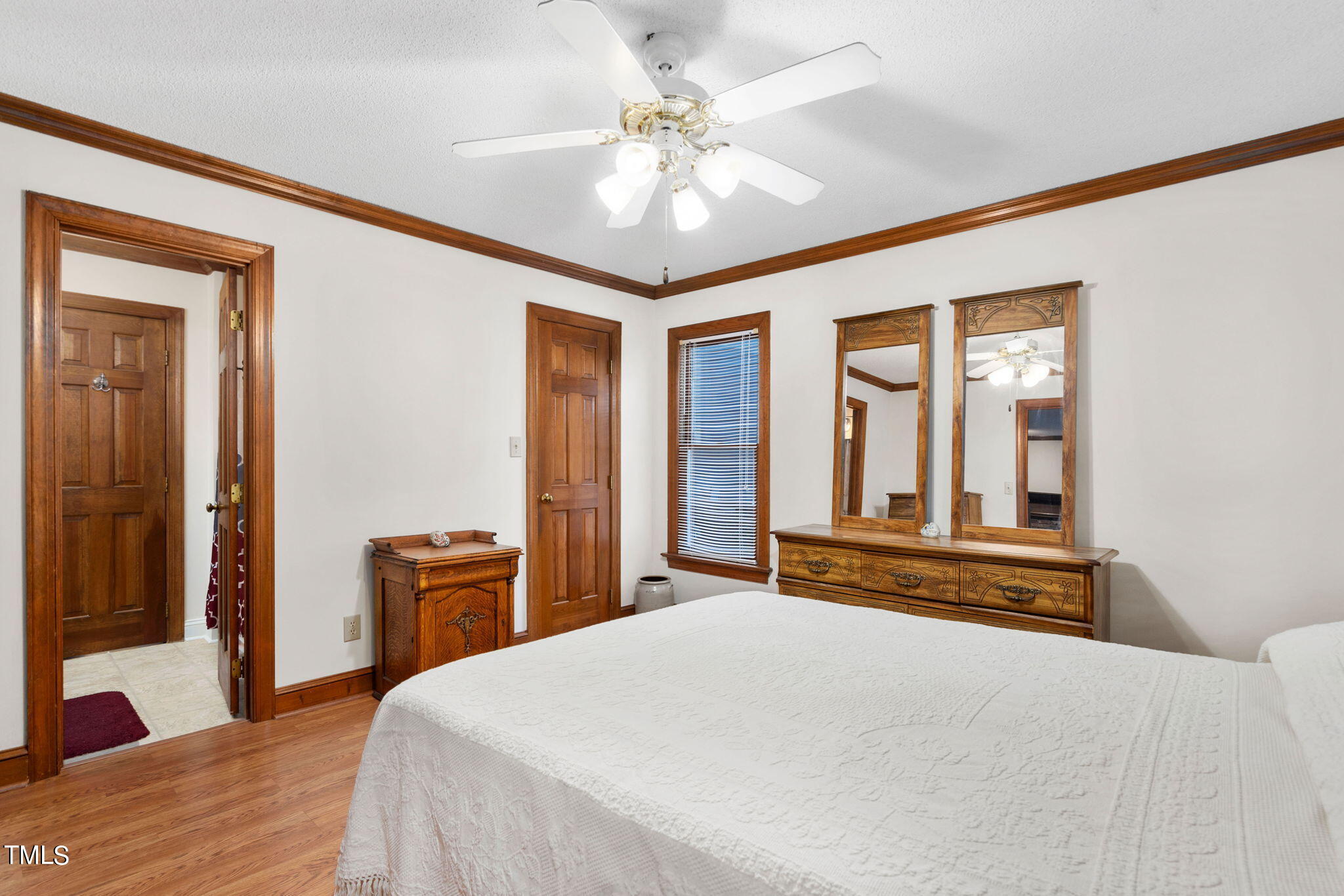 3205 Flintshire Road Raleigh, NC 27604 - Photo 8 of 31 a bedroom with a large bed and a chandelier