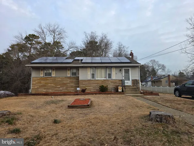 a front view of a house with cars parked