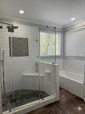 a bathroom with a shower and a bathtub
