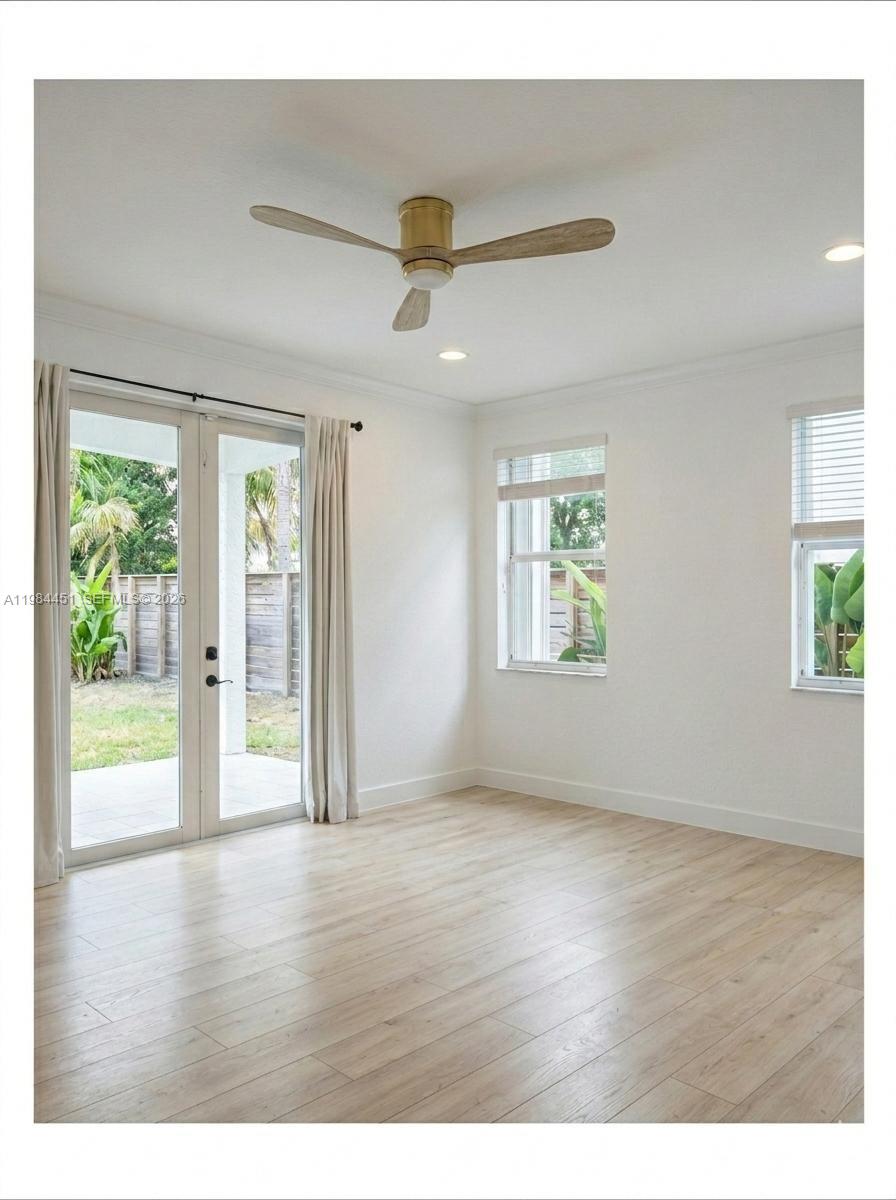 16364 Southwest 63rd Terrace Miami, FL 33193 - Photo 19 of 20 a view of an empty room with wooden floor and a window