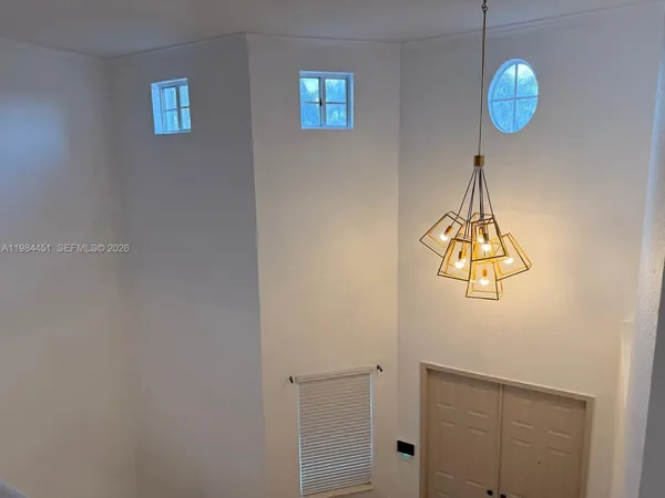 a view of a chandelier fan and wooden floor