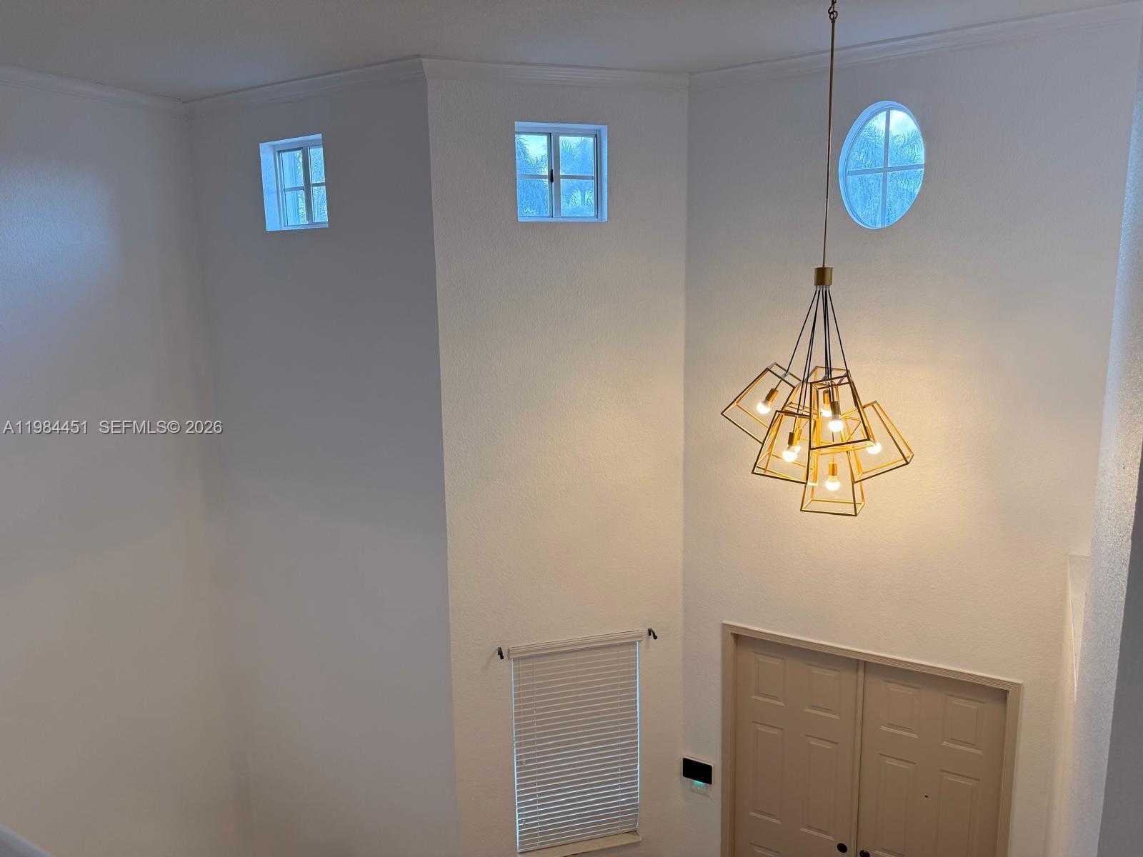16364 Southwest 63rd Terrace Miami, FL 33193 - Photo 4 of 20 a view of a chandelier fan and wooden floor
