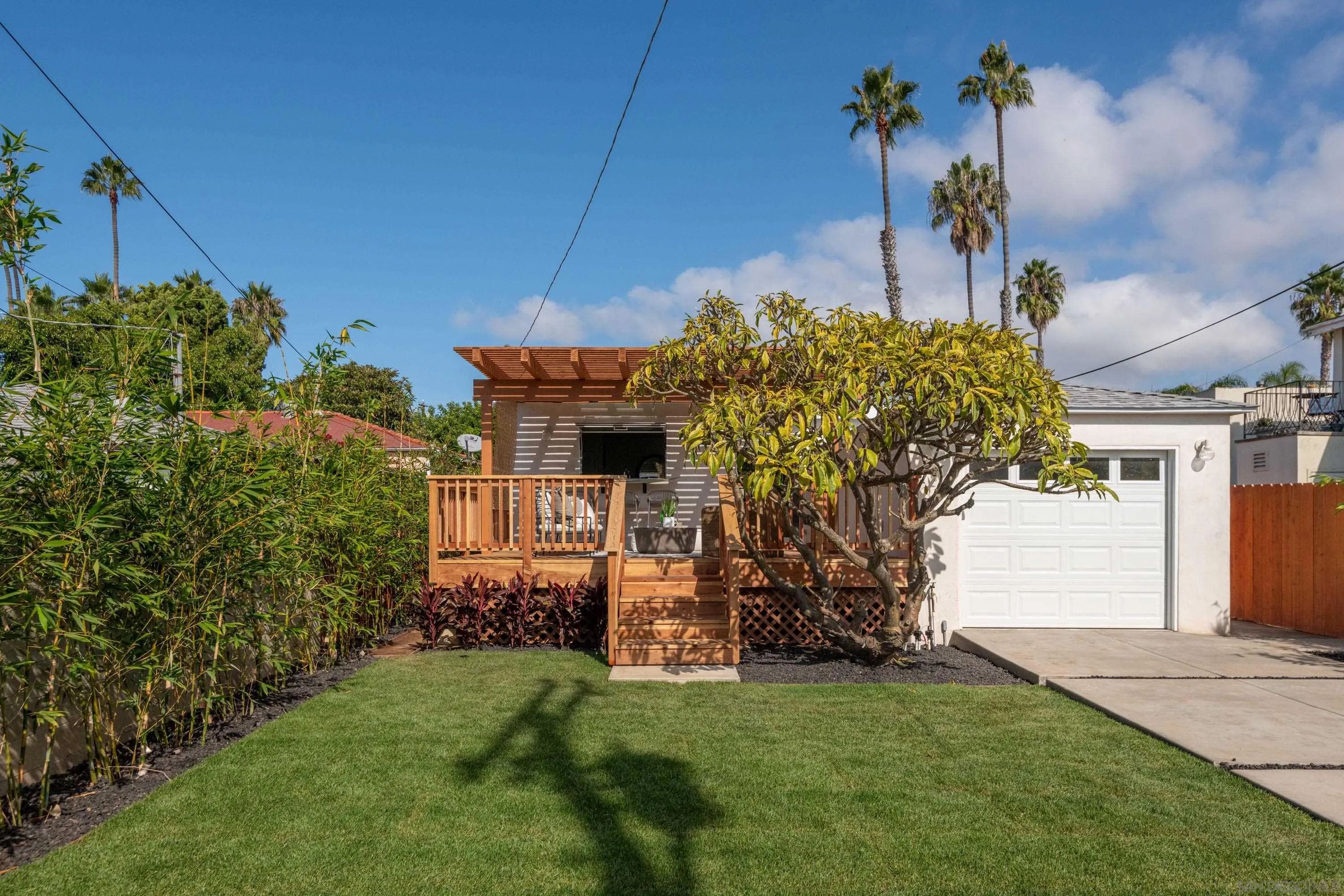 1025 Wilbur Avenue San Diego, CA 92109 - Photo 19 of 52 a view of a house with a small yard and potted plants