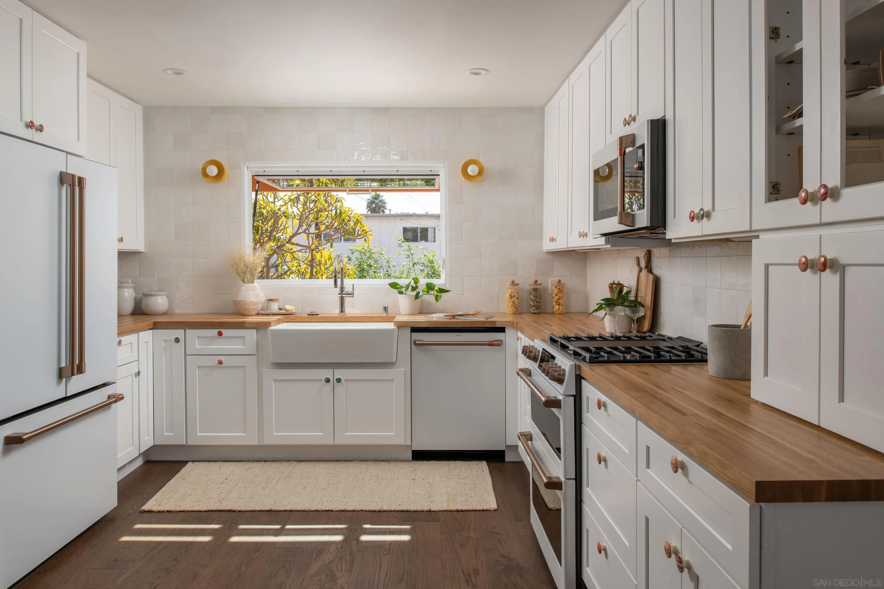 1025 Wilbur Avenue San Diego, CA 92109 - Photo 4 of 52 a kitchen with white cabinets and appliances