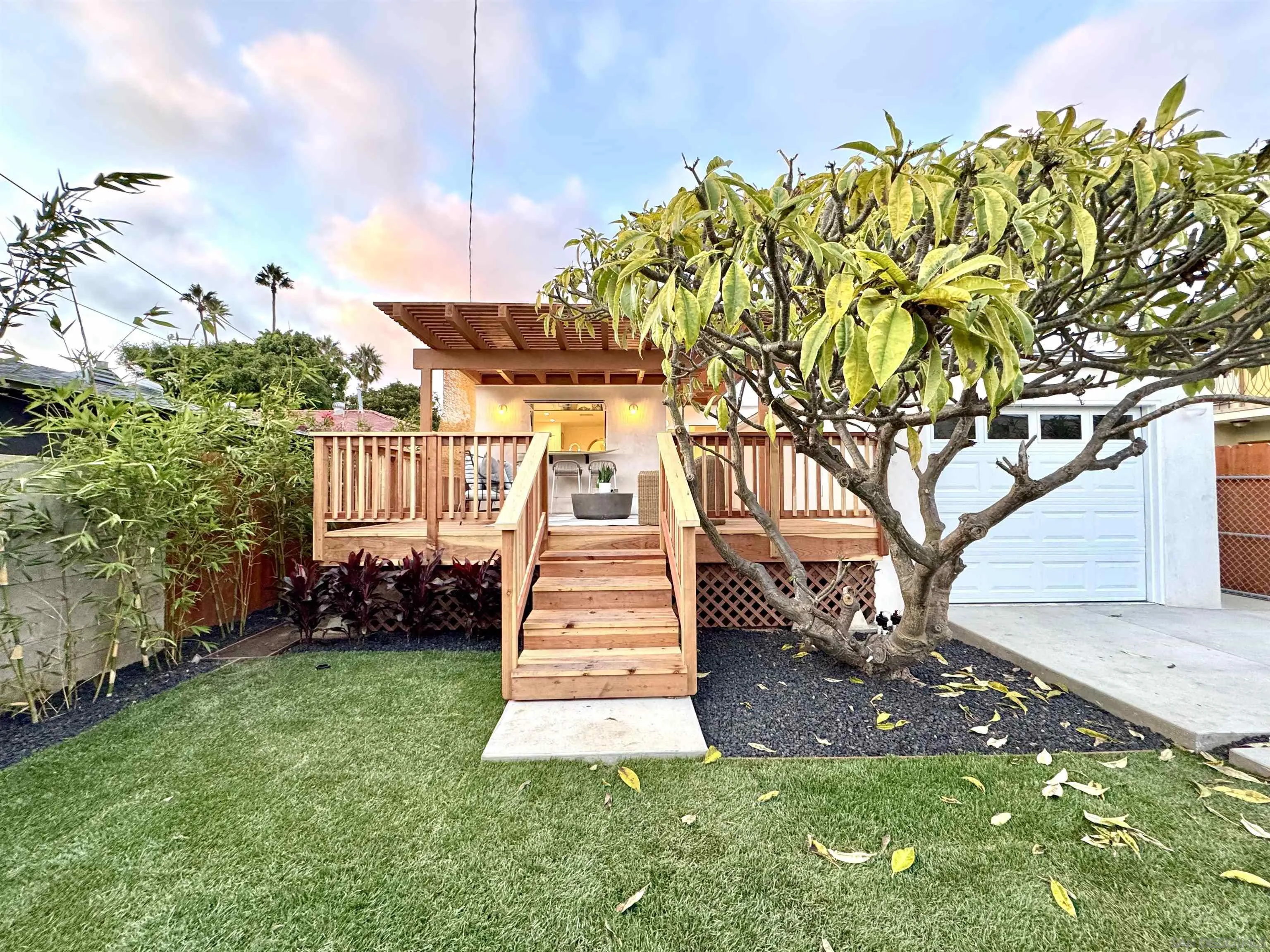 1025 Wilbur Avenue San Diego, CA 92109 - Photo 48 of 52 a front view of a house with a yard and fountain