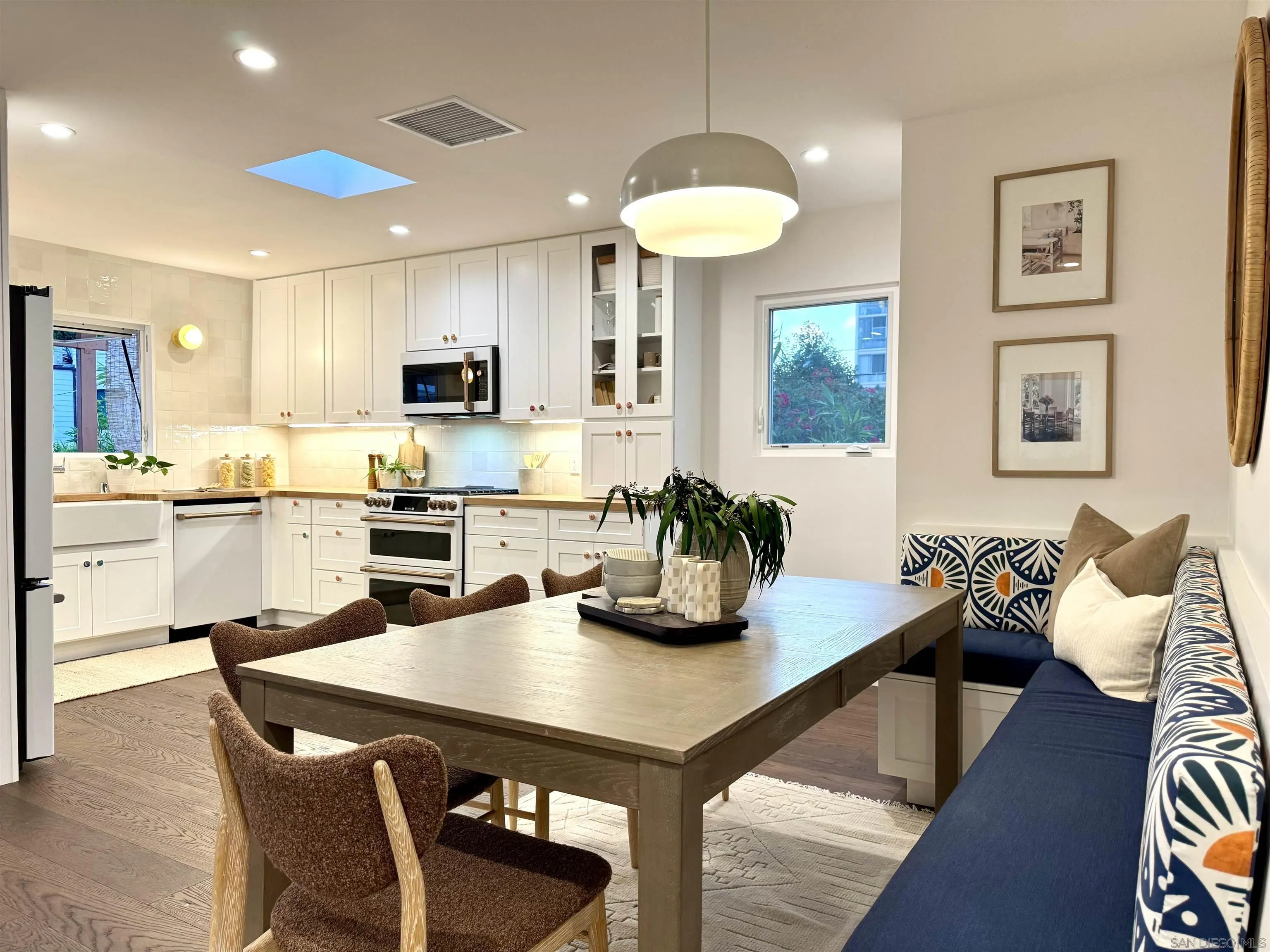 1025 Wilbur Avenue San Diego, CA 92109 - Photo 50 of 52 a kitchen with a table chairs microwave and cabinets