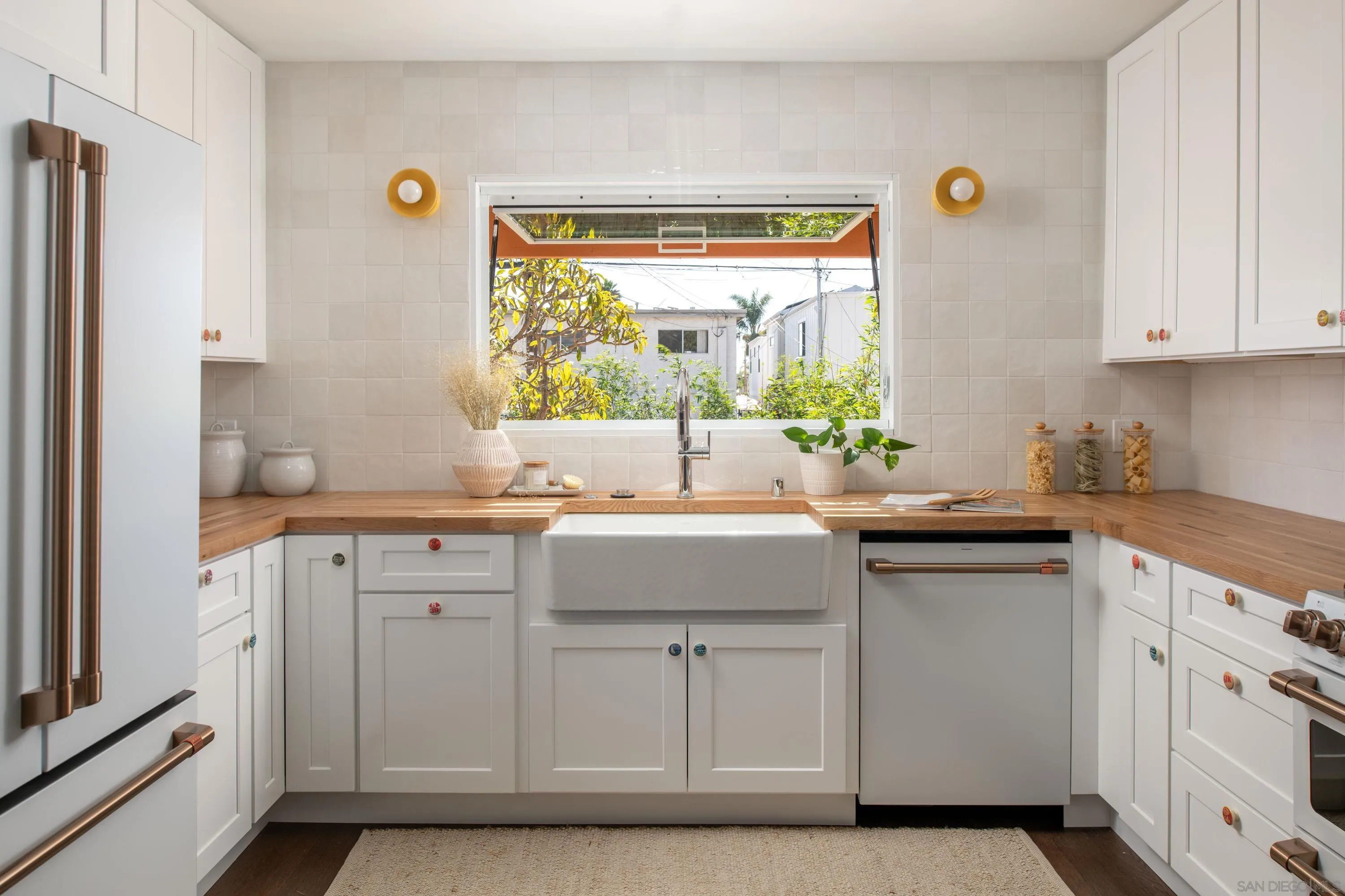 1025 Wilbur Avenue San Diego, CA 92109 - Photo 6 of 52 a kitchen with white cabinets and a window