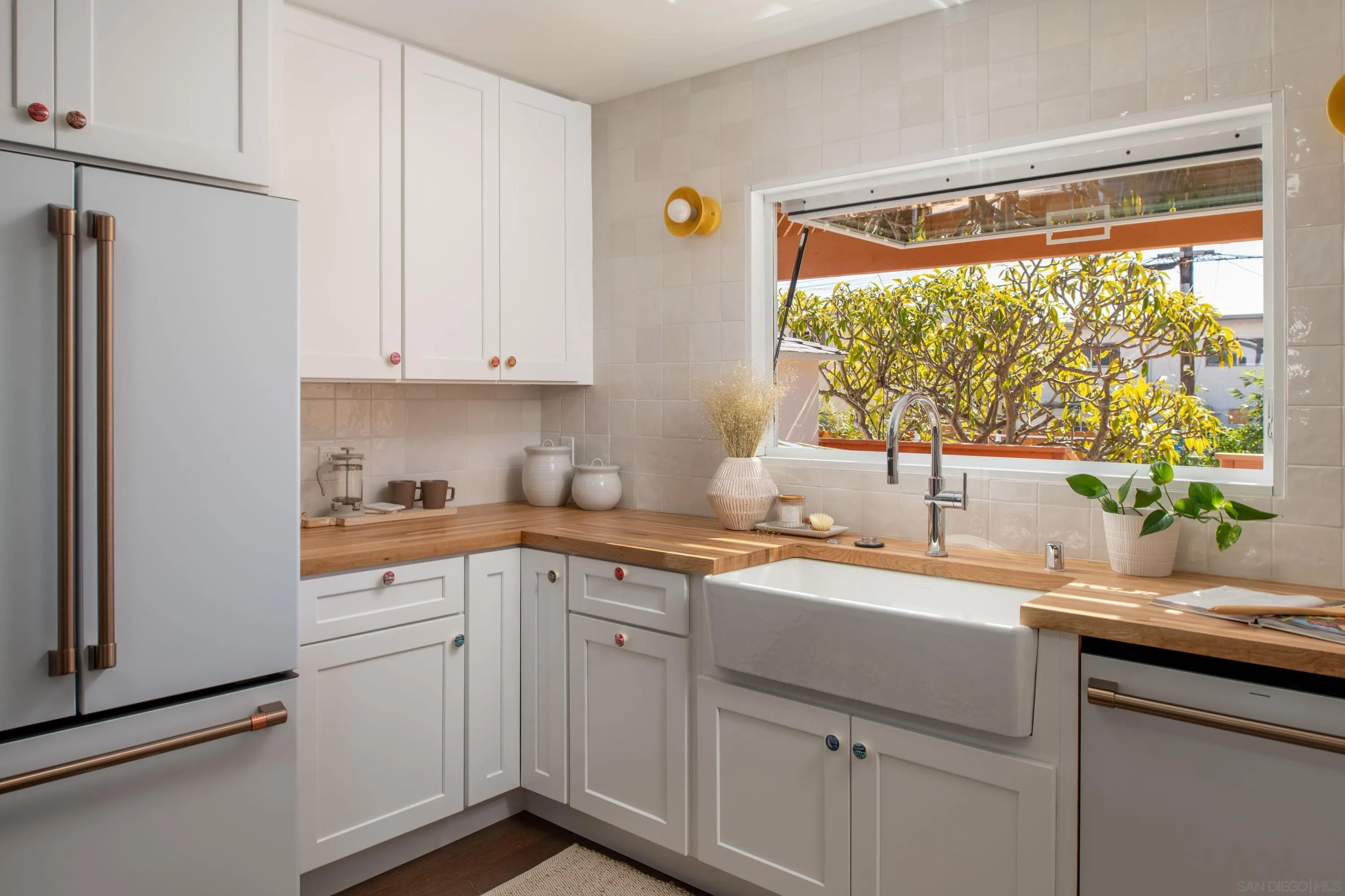 1025 Wilbur Avenue San Diego, CA 92109 - Photo 7 of 52 a kitchen with a sink window and cabinets