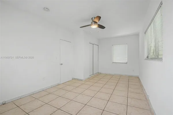 a view of an empty room and a window