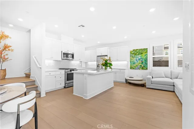 a kitchen with stainless steel appliances kitchen island granite countertop a sink and cabinets