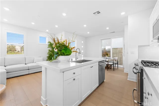 a living room with furniture and a kitchen