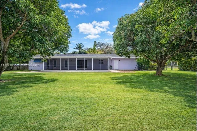 a front view of house with yard and green space