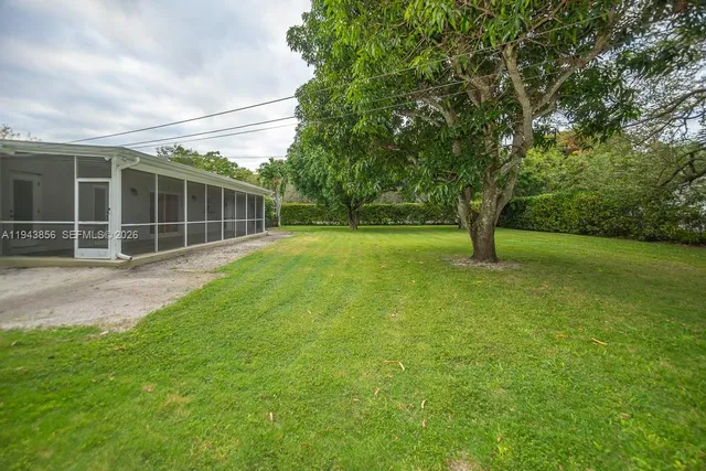 a view of an house with backyard space and garden