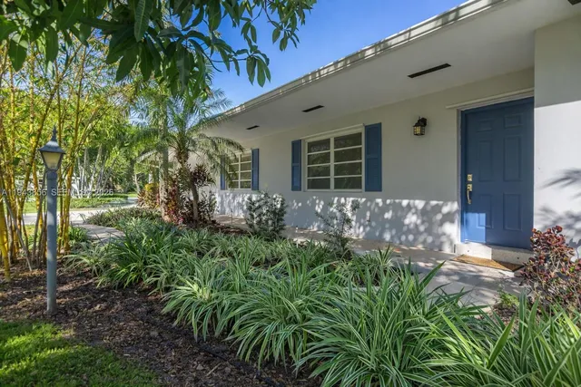 a flower plants in front of a house