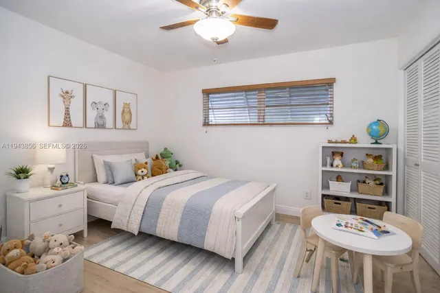 a bedroom with a bed and a bookshelf