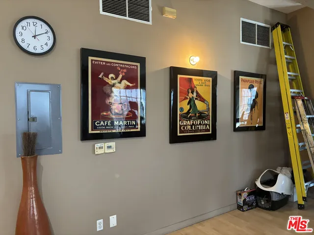 a view of a hallway with paintings on the wall