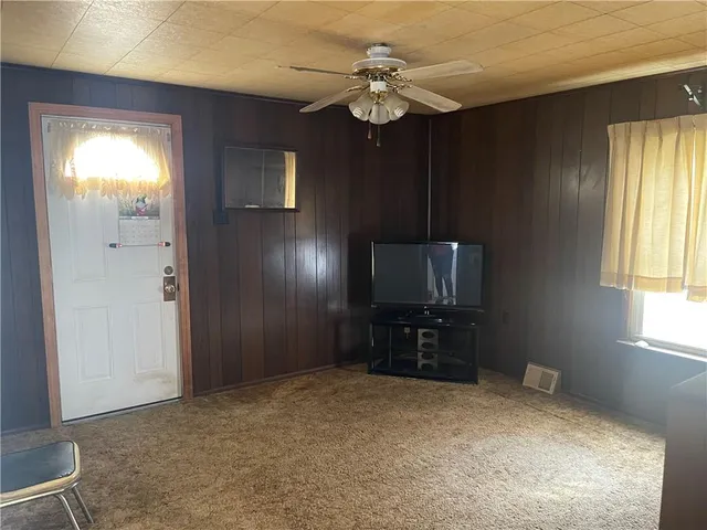 a view of empty room with ceiling fan