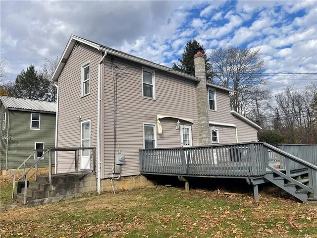 a kitchen with a table chairs sink and cabinets