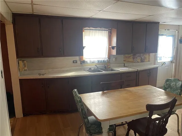 an empty room with windows and cabinet