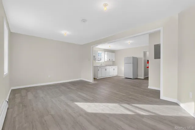 a view of a kitchen with a refrigerator and a sink