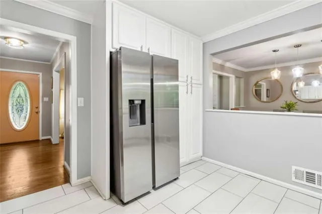 a kitchen with stainless steel appliances granite countertop white cabinets and window