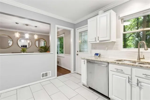 a kitchen with stainless steel appliances and white cabinets
