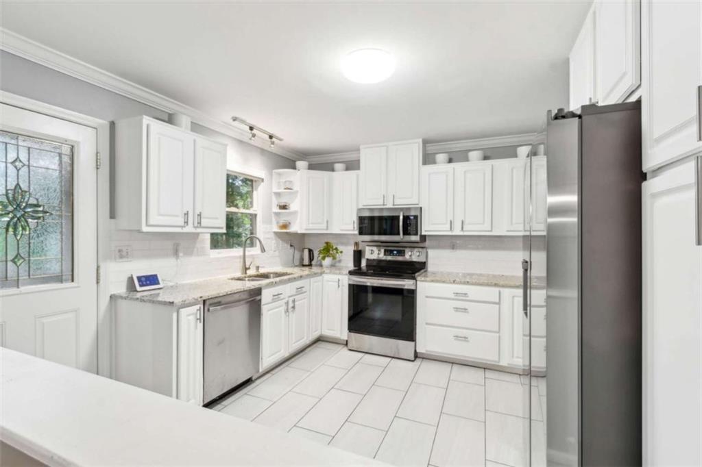 3362 Northbrook Drive Atlanta, GA 30340 - Photo 20 of 55 a kitchen with stainless steel appliances and white cabinets