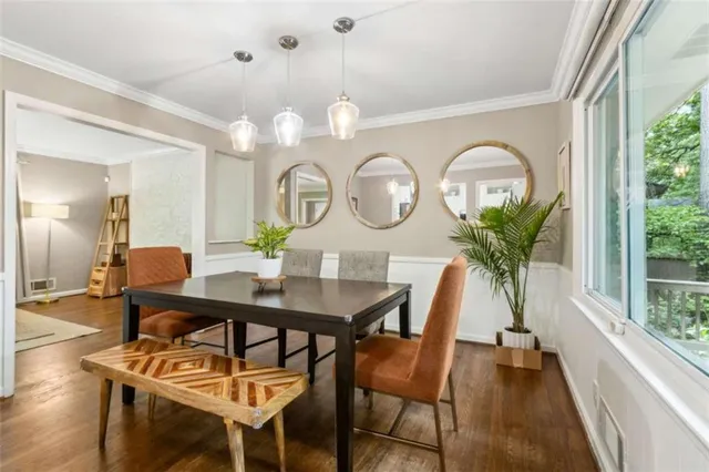 a view of a dining room with furniture a chandelier and wooden floor