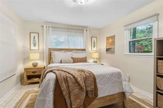 a bedroom with a bed and a painting on the wall