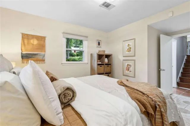 a bedroom with a bed window and a rug