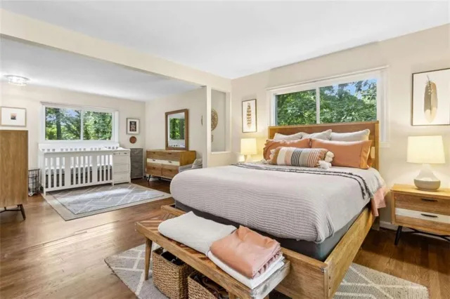 a bedroom with a bed and a large mirror