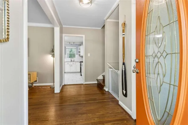 a view of a hallway with wooden floor and glass door