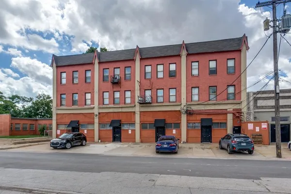 a car parked in front of a brick building