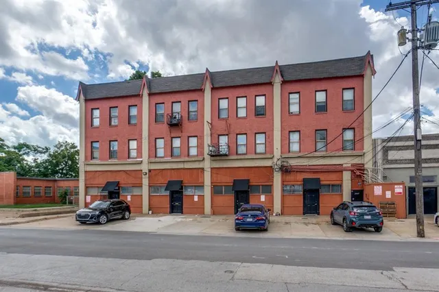 a car parked in front of a brick building