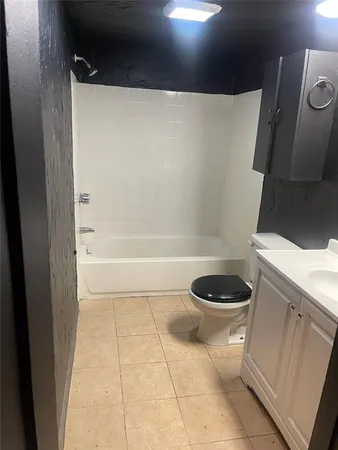 a bathroom with a toilet a sink and bathtub