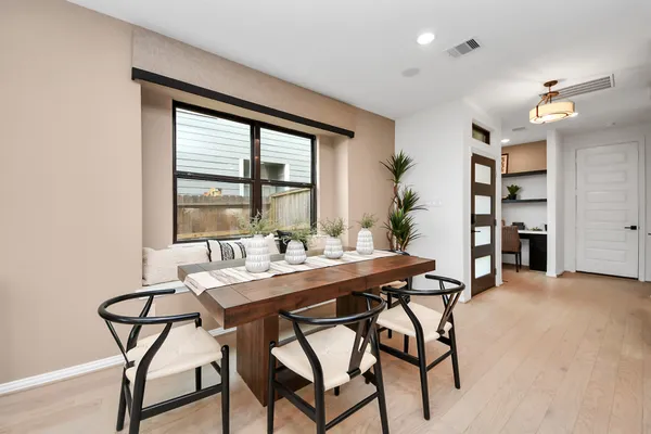 a kitchen with stainless steel appliances kitchen island granite countertop a refrigerator a stove a kitchen island with a dining table and chairs