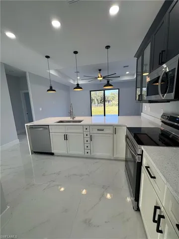 a kitchen that has a lot of cabinets in it