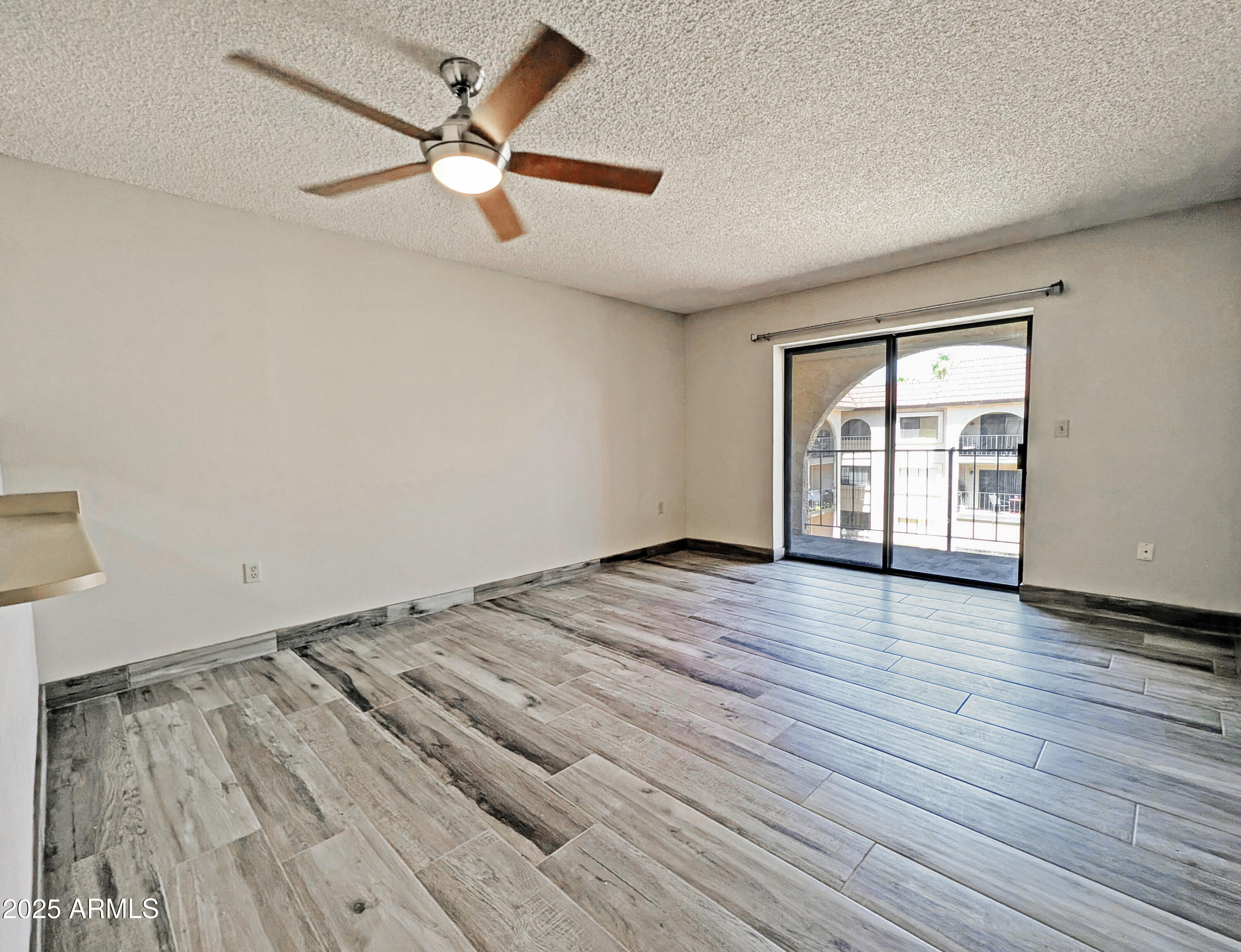3033 East Devonshire Avenue, Unit 3034 Phoenix, AZ 85016 - Photo 1 of 14 wooden floor in an empty room with a window