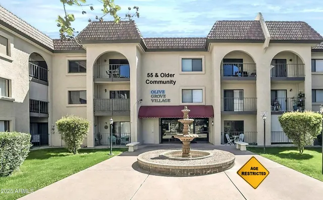 a front view of a brick house with a yard