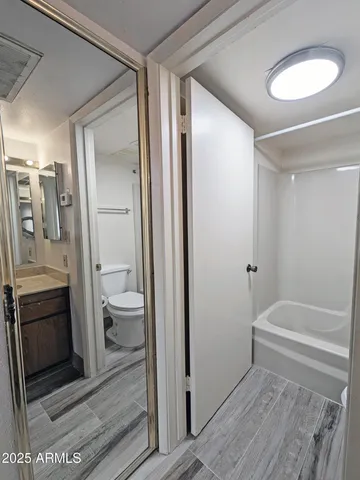 a bathroom with a tub and a toilet