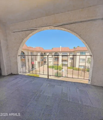 a view of an empty room with a balcony