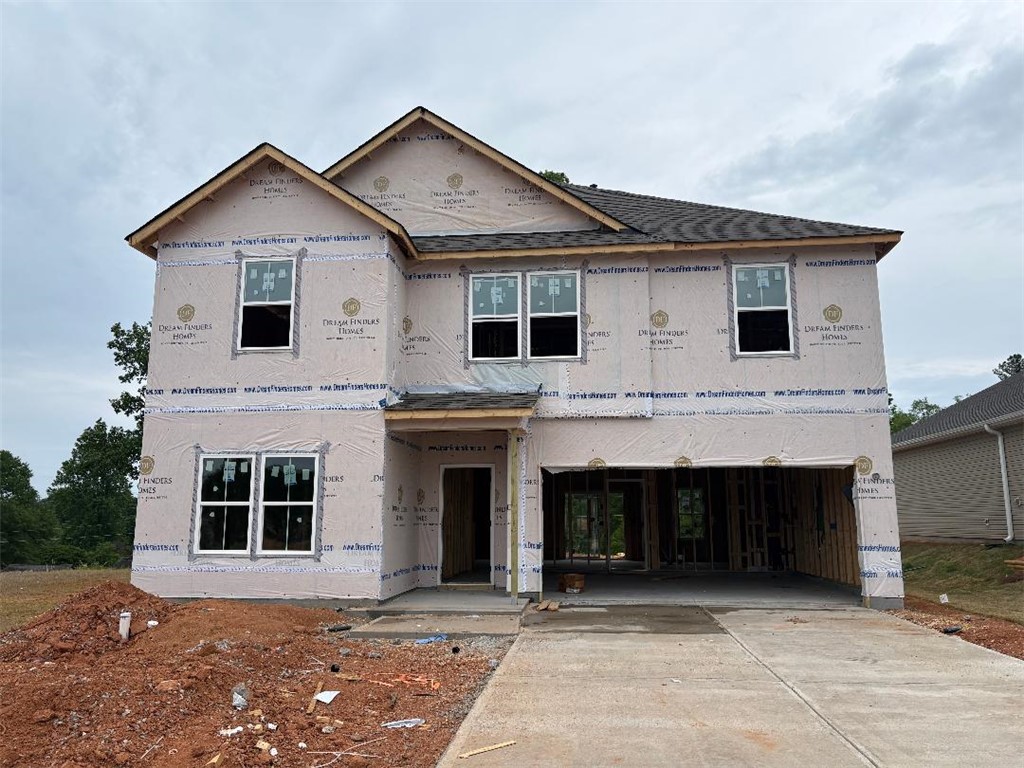 152 Cedar Shoals Easley, SC 29640 - Photo 1 of 15 A newly constructed home awaiting its final touches stands under a bright sky.