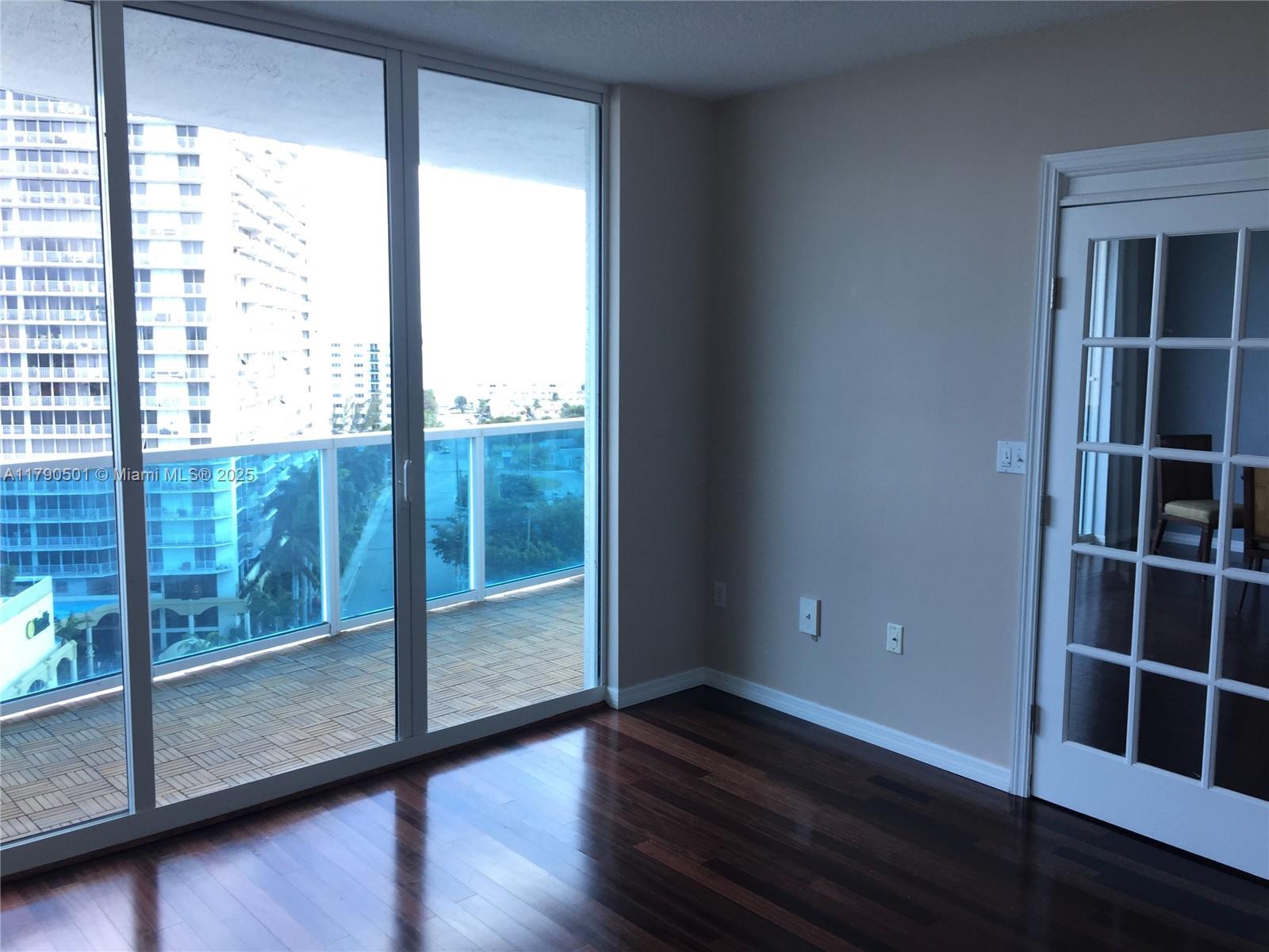 1881 79th Street Causeway, Unit 1106 North Bay Village, FL 33141 - Photo 16 of 20 a view of wooden floor and windows in a room